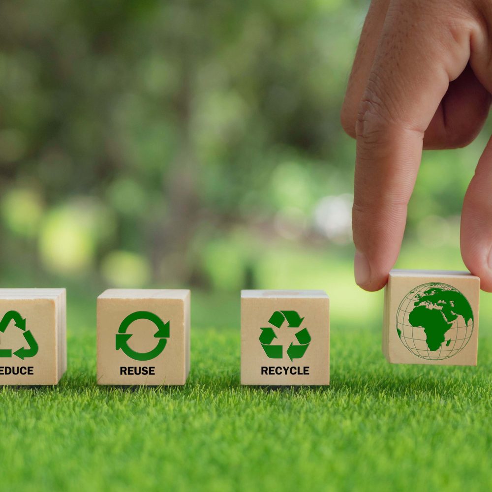 hand arranged wooden cube block over reduce, reuse and recycle text for save world, environmental concept