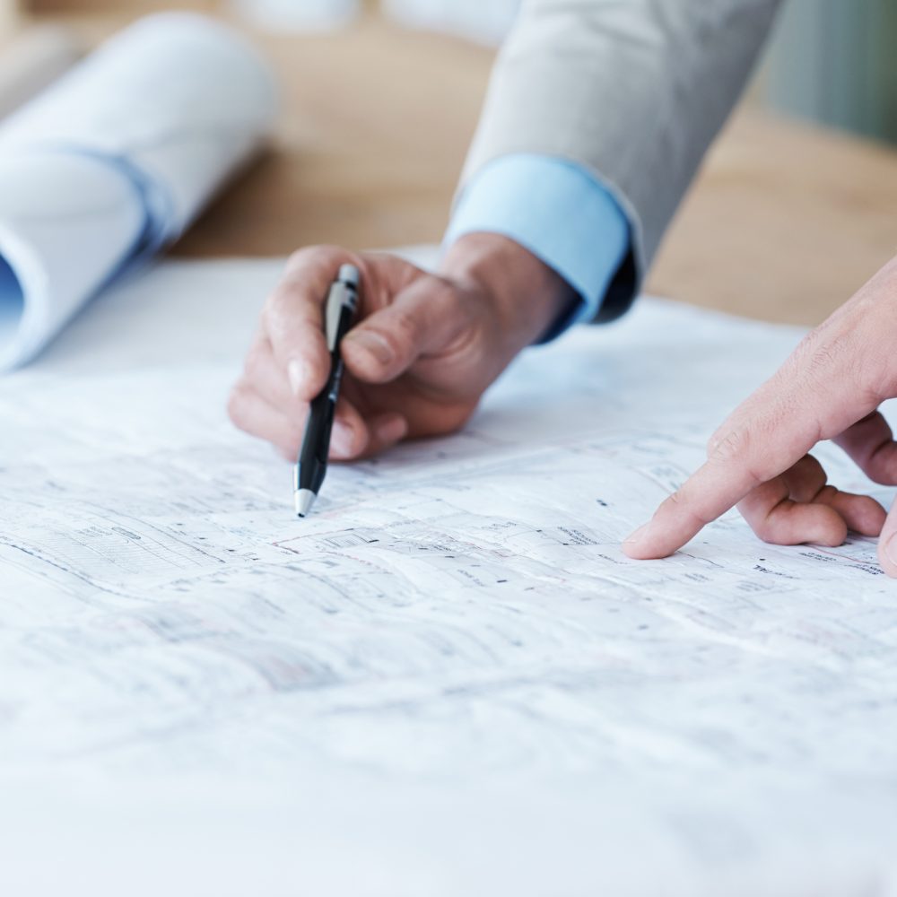 Close up of architects going over the building plans